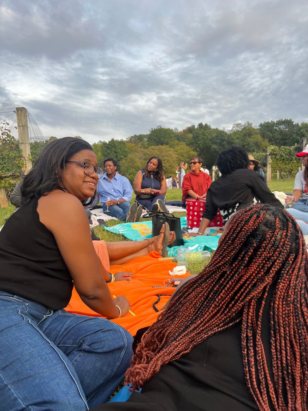 Women laughing together at a Village sisterhood gathering